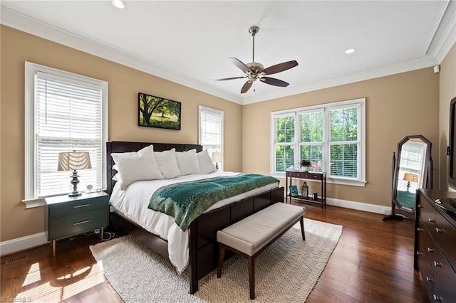 bedroom featuring baseboards, ornamental molding, dark wood-style flooring, and ceiling fan