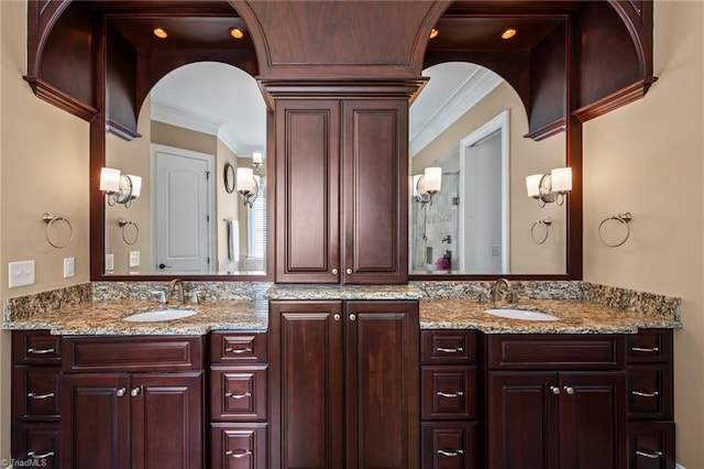 full bathroom featuring crown molding, double vanity, ornate columns, and a sink