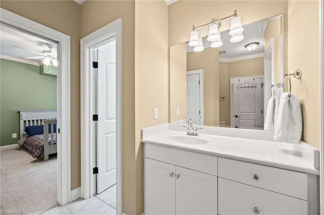 bathroom featuring crown molding, ceiling fan, baseboards, and vanity