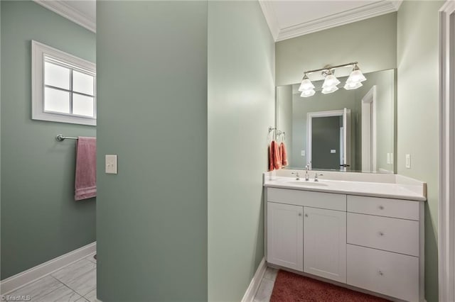 bathroom with baseboards, ornamental molding, and vanity