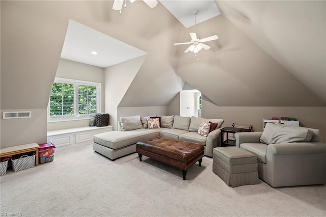 living area featuring carpet floors, a ceiling fan, visible vents, and lofted ceiling