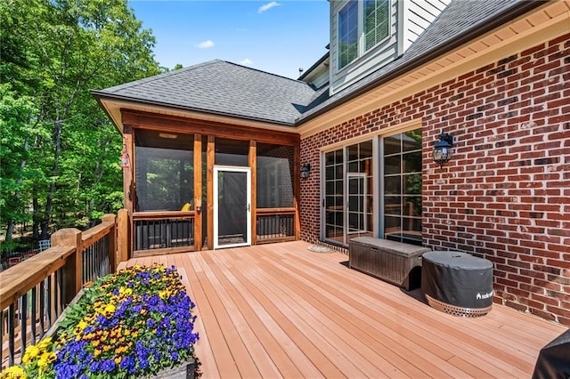 wooden deck with a sunroom