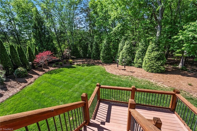 wooden deck featuring a lawn
