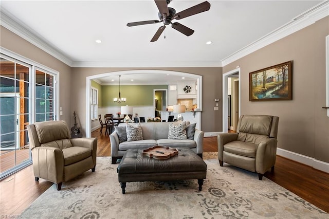 living room featuring baseboards, arched walkways, ceiling fan with notable chandelier, and wood finished floors