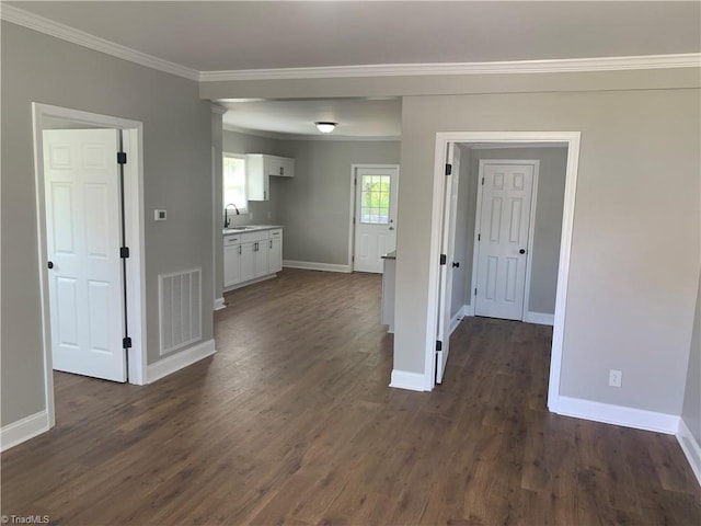 interior space featuring visible vents, crown molding, baseboards, and dark wood-style floors