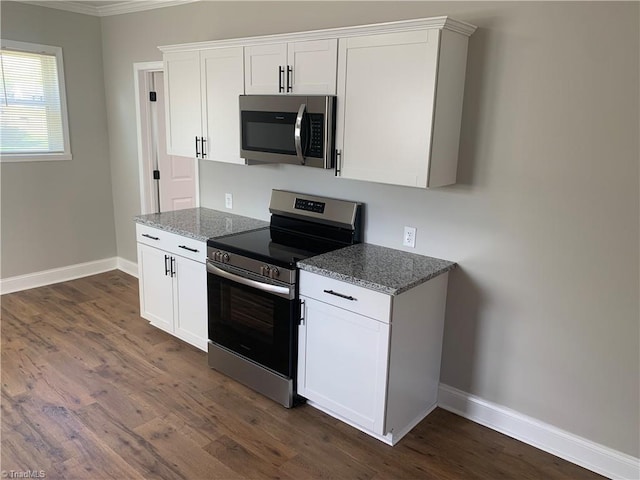 kitchen with stainless steel appliances, dark wood-style flooring, baseboards, light stone countertops, and ornamental molding