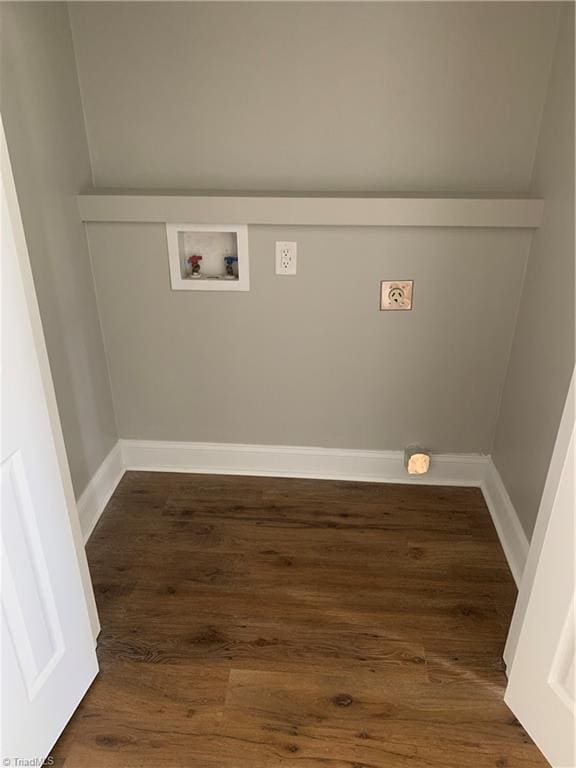 laundry room with dark wood finished floors, hookup for a washing machine, baseboards, and laundry area