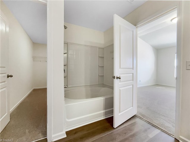 full bathroom with baseboards, wood finished floors, and bathtub / shower combination