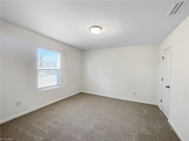 unfurnished room featuring visible vents, carpet floors, and baseboards