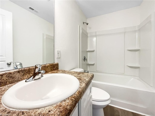 full bath with visible vents, toilet, wood finished floors, shower / washtub combination, and vanity