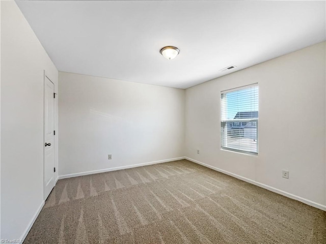 unfurnished room featuring visible vents, baseboards, and carpet floors