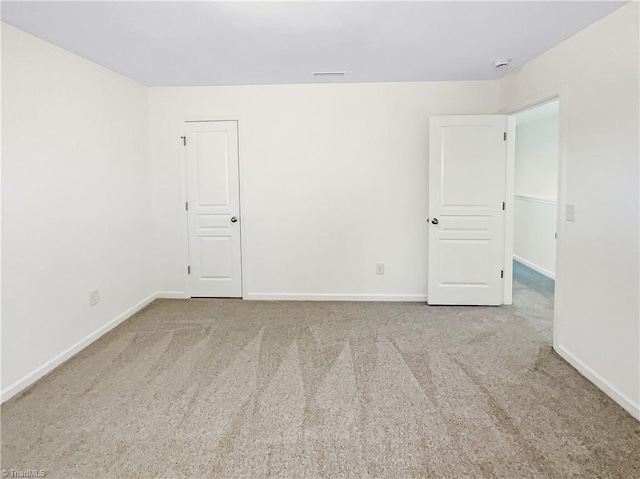 empty room with carpet flooring and baseboards