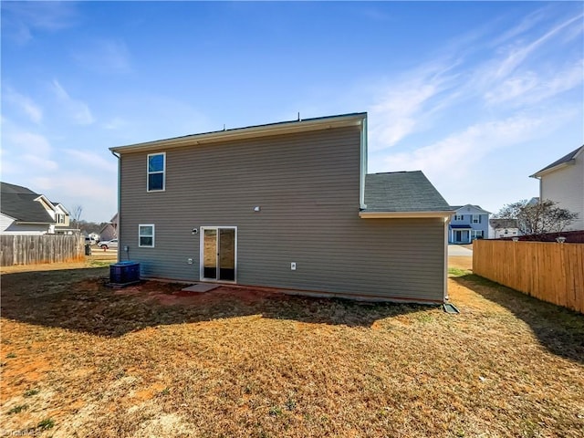 back of house with fence and central AC