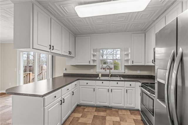 kitchen featuring a wealth of natural light, white cabinetry, sink, kitchen peninsula, and stainless steel appliances