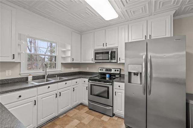 kitchen featuring white cabinets, stainless steel appliances, and sink