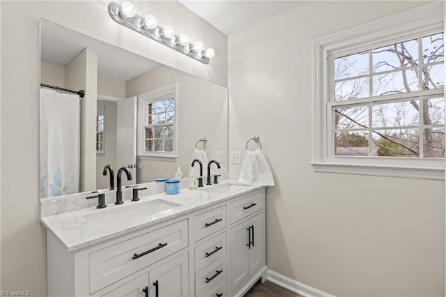 bathroom with plenty of natural light and vanity