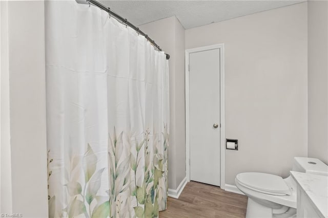 bathroom with vanity, hardwood / wood-style flooring, and a textured ceiling