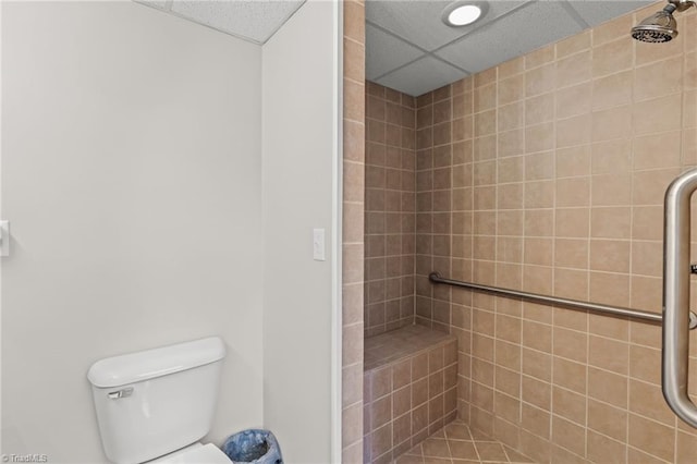 bathroom featuring toilet and tiled shower