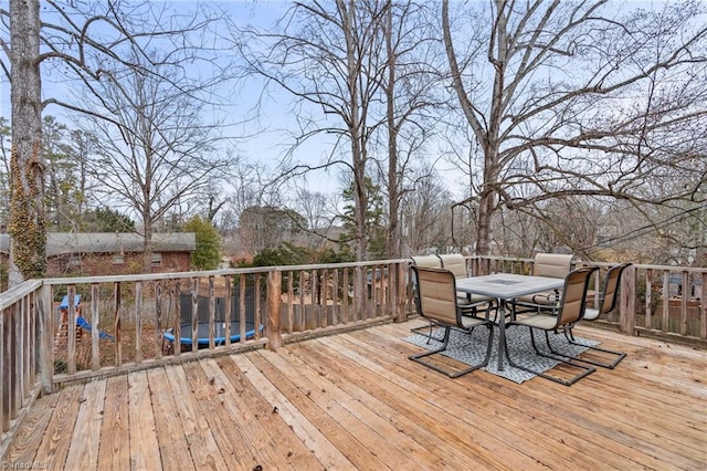 wooden deck featuring a trampoline