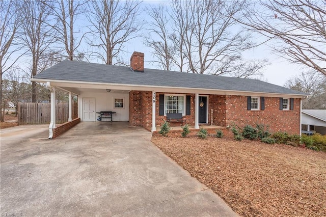 view of front of property with covered porch and a carport