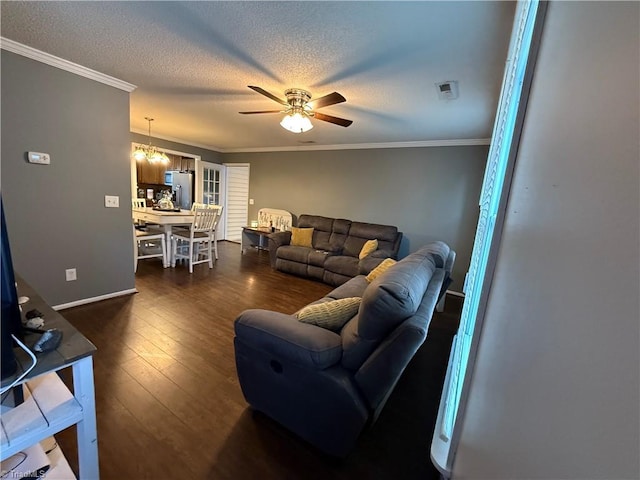 living room featuring crown molding, dark wood-type flooring, ceiling fan with notable chandelier, and a textured ceiling