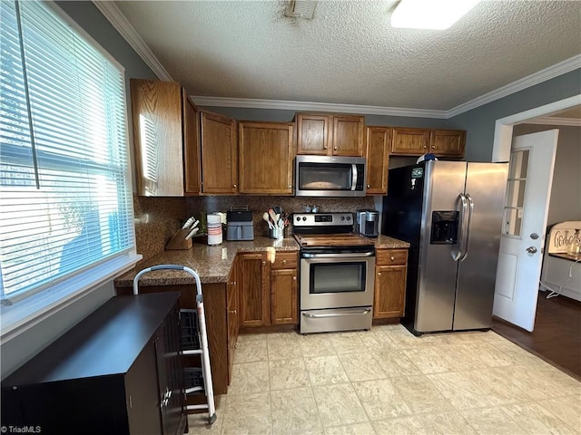 kitchen featuring decorative backsplash, ornamental molding, stainless steel appliances, and stone counters