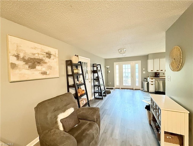 sitting room featuring hardwood / wood-style floors and a textured ceiling