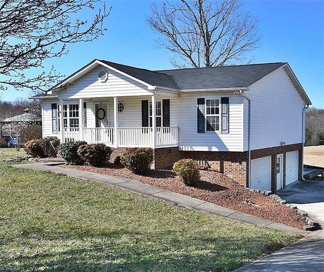 view of front of home with a front yard, an attached garage, covered porch, and driveway