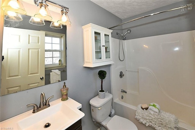 full bath featuring toilet, a textured ceiling, vanity, and shower / bathing tub combination