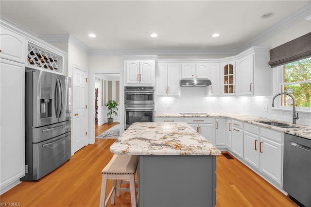 6707 Fegan Rd, Summerfield, NC 27358 - kitchen featuring appliances with stainless steel finishes, white cabinets, light stone countertops, decorative backsplash, and glass insert cabinets