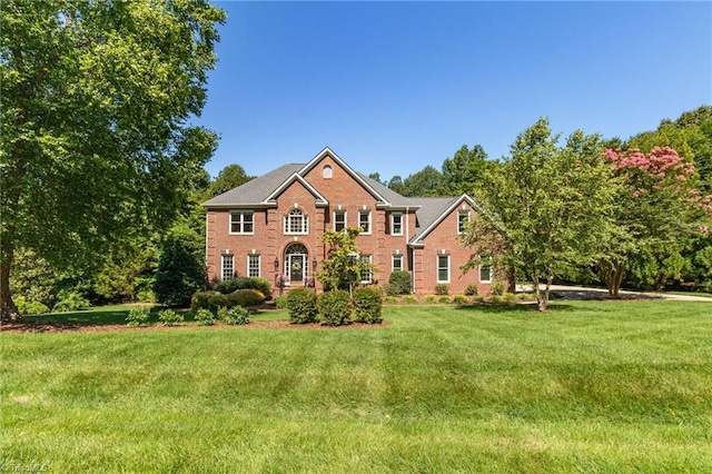 6707 Fegan Rd, Summerfield, NC 27358 - view of front of house featuring brick siding and a front lawn
