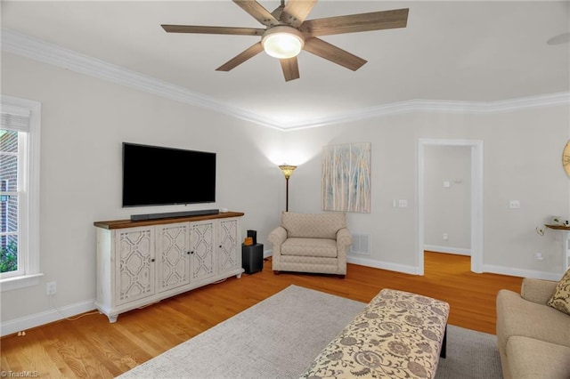 6707 Fegan Rd, Summerfield, NC 27358 - living room featuring ornamental molding, healthy amount of natural light, wood finished floors, and ceiling fan