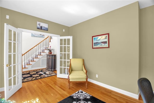 6707 Fegan Rd, Summerfield, NC 27358 - sitting room with wood finished floors, french doors, and stairway