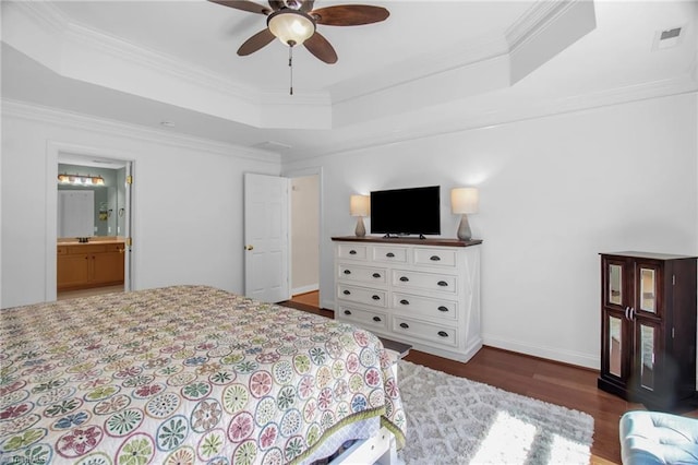 6707 Fegan Rd, Summerfield, NC 27358 - bedroom featuring wood finished floors, a raised ceiling, ornamental molding, ceiling fan, and connected bathroom