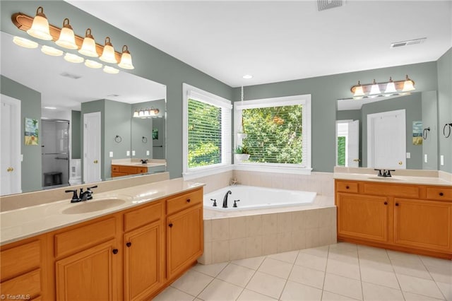 6707 Fegan Rd, Summerfield, NC 27358 - bathroom featuring two vanities, a bath, tile patterned floors, and a shower stall