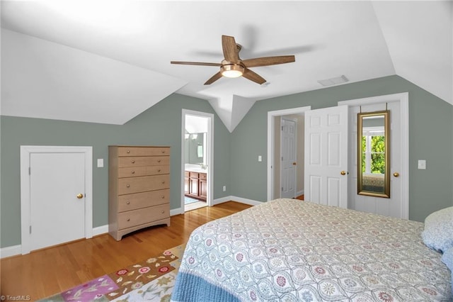 6707 Fegan Rd, Summerfield, NC 27358 - bedroom featuring wood finished floors, vaulted ceiling, connected bathroom, and ceiling fan