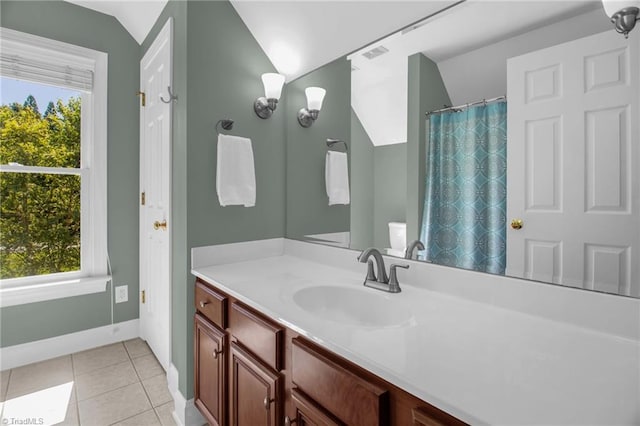 6707 Fegan Rd, Summerfield, NC 27358 - bathroom with vanity, healthy amount of natural light, tile patterned flooring, a shower with shower curtain, and vaulted ceiling