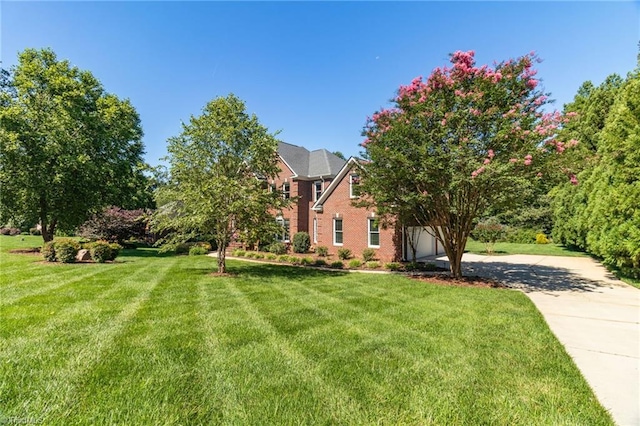 6707 Fegan Rd, Summerfield, NC 27358 - view of front of house with concrete driveway, a garage, and a front yard