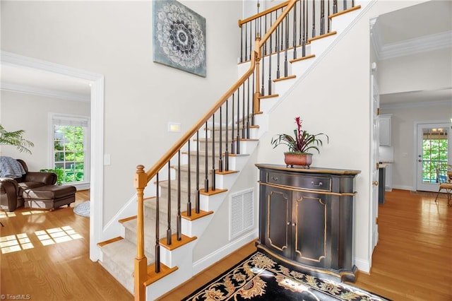 6707 Fegan Rd, Summerfield, NC 27358 - staircase with wood finished floors and ornamental molding