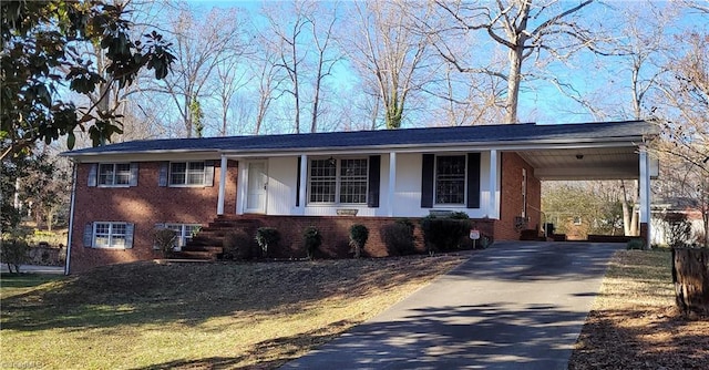 view of front of property featuring a carport, concrete driveway, and brick siding