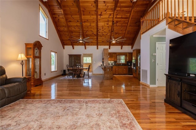 living room featuring wood ceiling, high vaulted ceiling, ceiling fan, and light hardwood / wood-style floors