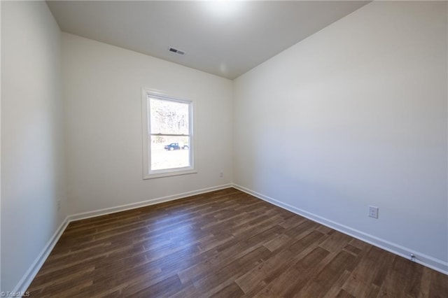 unfurnished room featuring dark hardwood / wood-style flooring