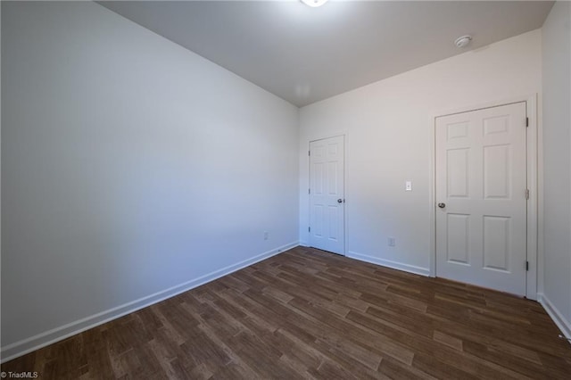 unfurnished room featuring dark hardwood / wood-style flooring