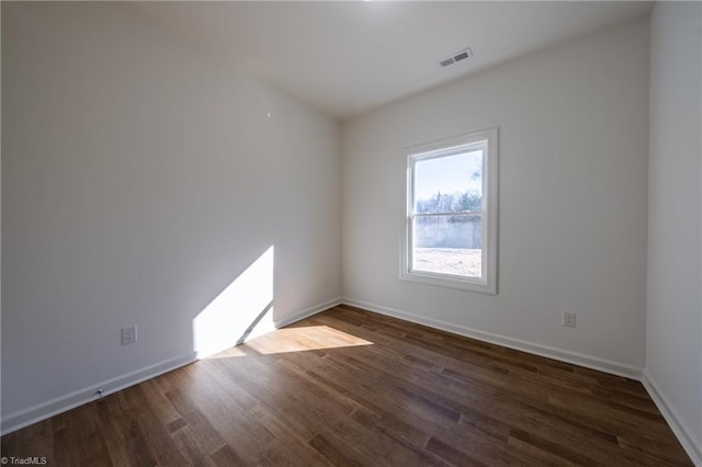 spare room with dark hardwood / wood-style floors