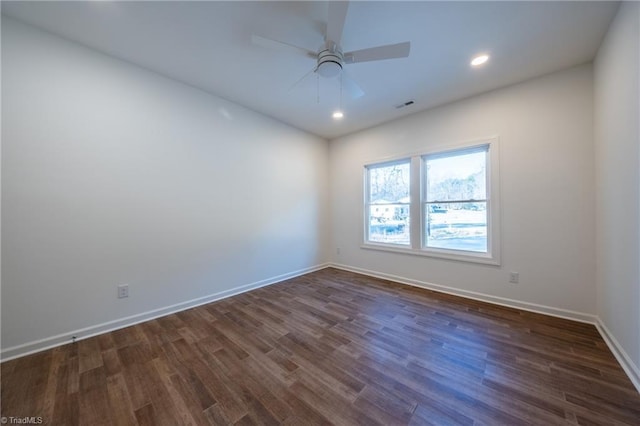 empty room featuring ceiling fan and dark hardwood / wood-style floors