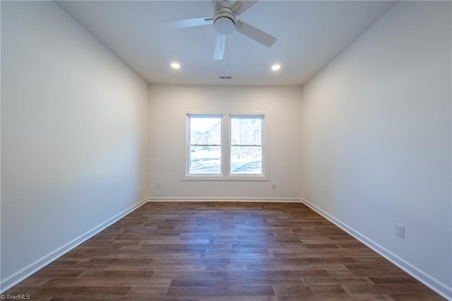 spare room featuring dark hardwood / wood-style floors and ceiling fan