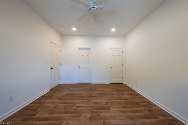 spare room with ceiling fan and dark wood-type flooring