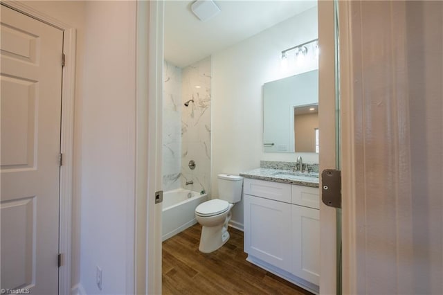 full bathroom with wood-type flooring, vanity, toilet, and tiled shower / bath