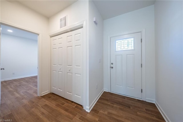 foyer entrance with dark hardwood / wood-style floors