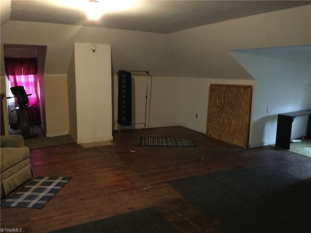 additional living space featuring lofted ceiling and wood finished floors